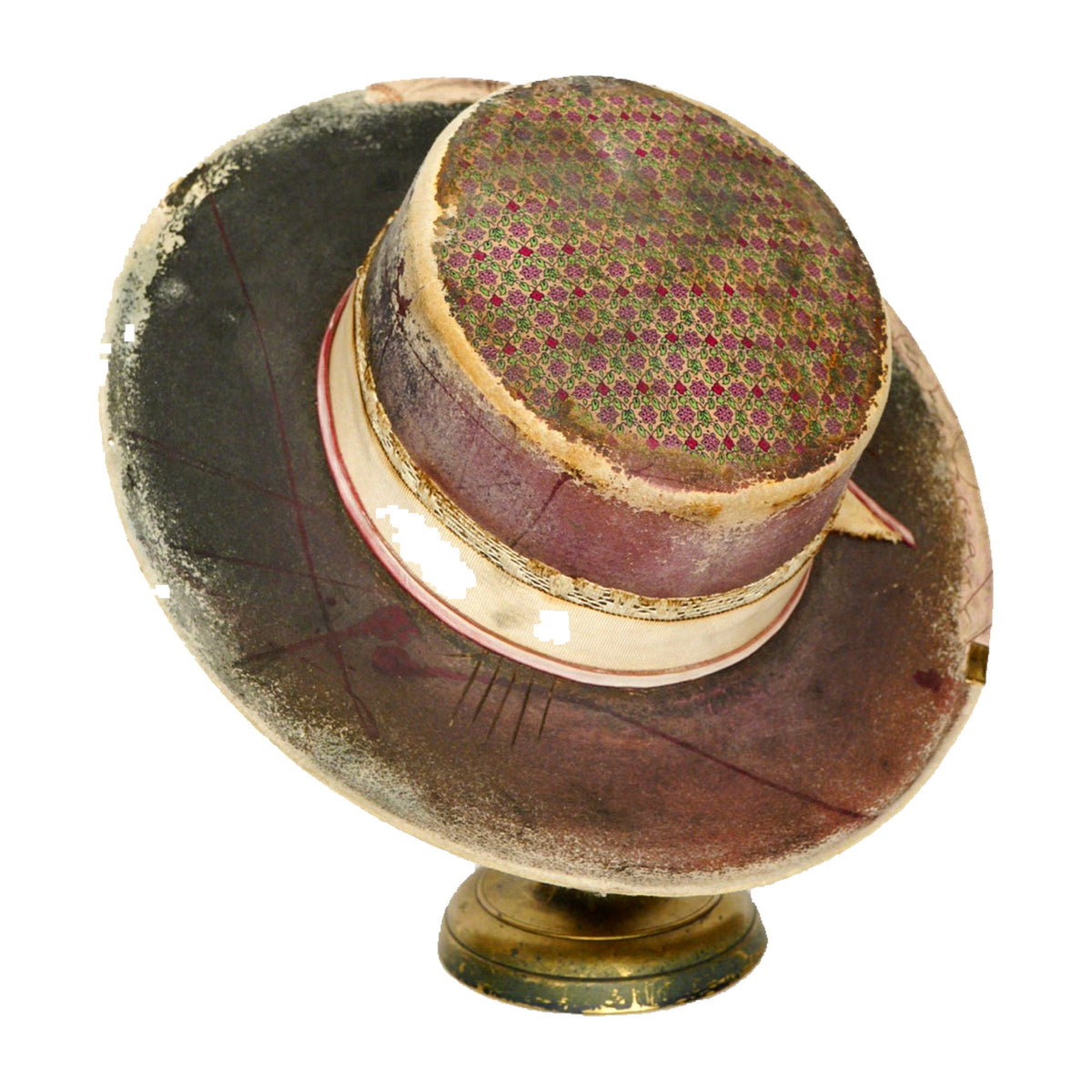 A vintage wide-brimmed hat with a dark brown and beige patterned brim, a burgundy crown, and a patterned band, displayed on a small round stand against a white background.