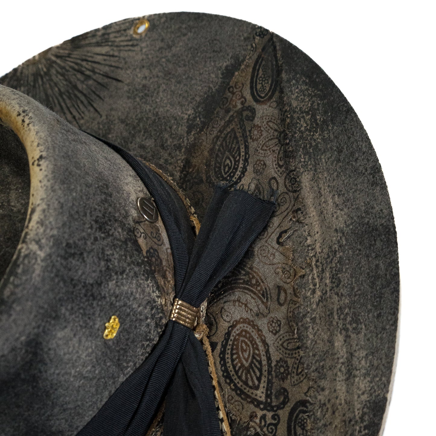 Burned symbolic markings and directional lines on distressed wide brim fur felt hat brim
