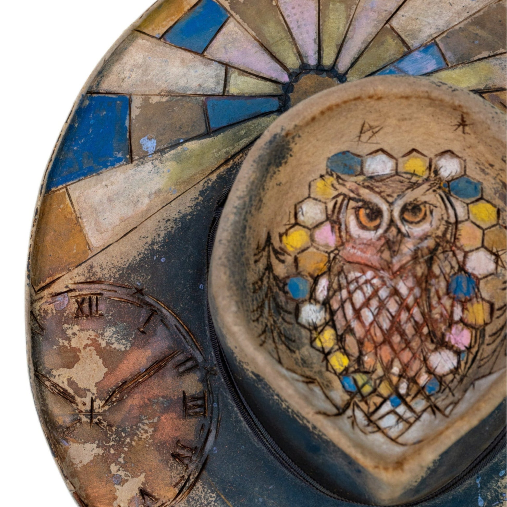 Close-up of hand-etched artwork on deep blue beaver fur felt crown
