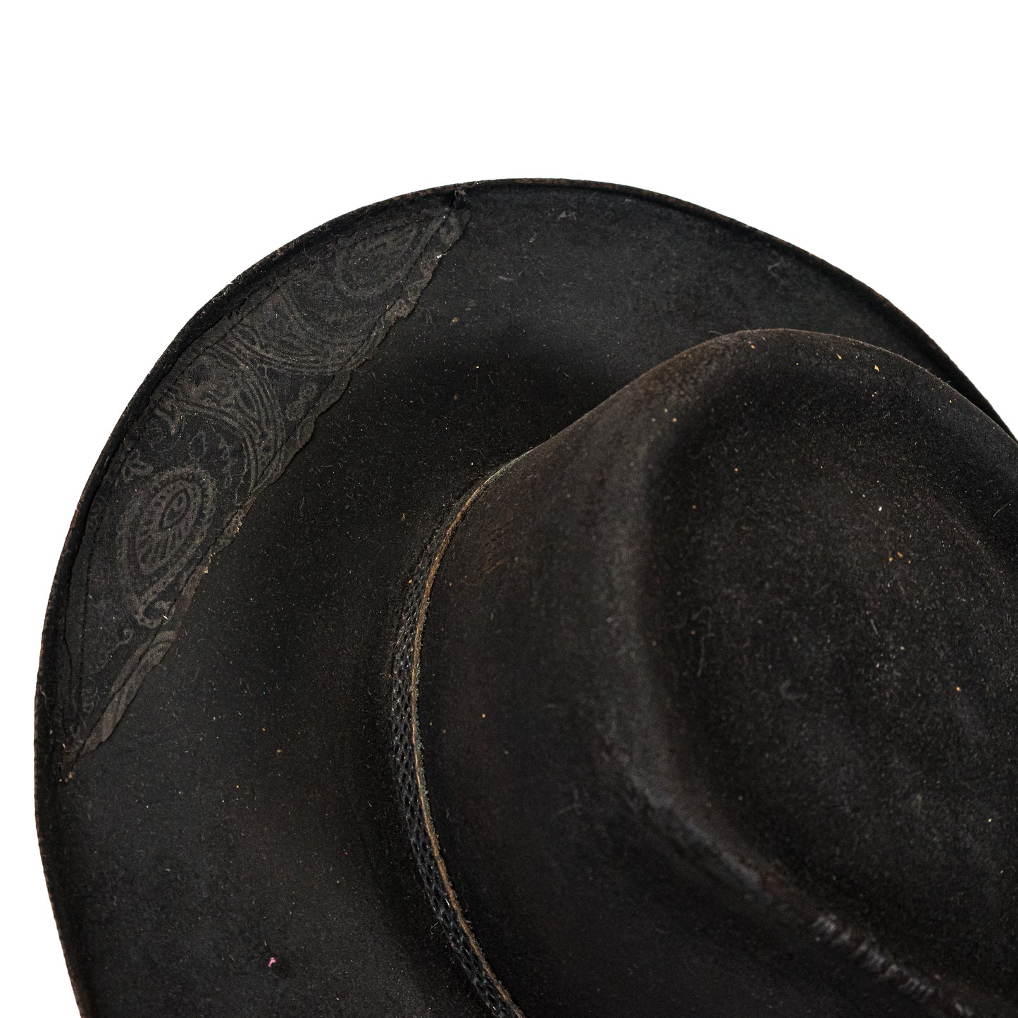 Close-up of heavily distressed black fur felt with burnished brim edges
