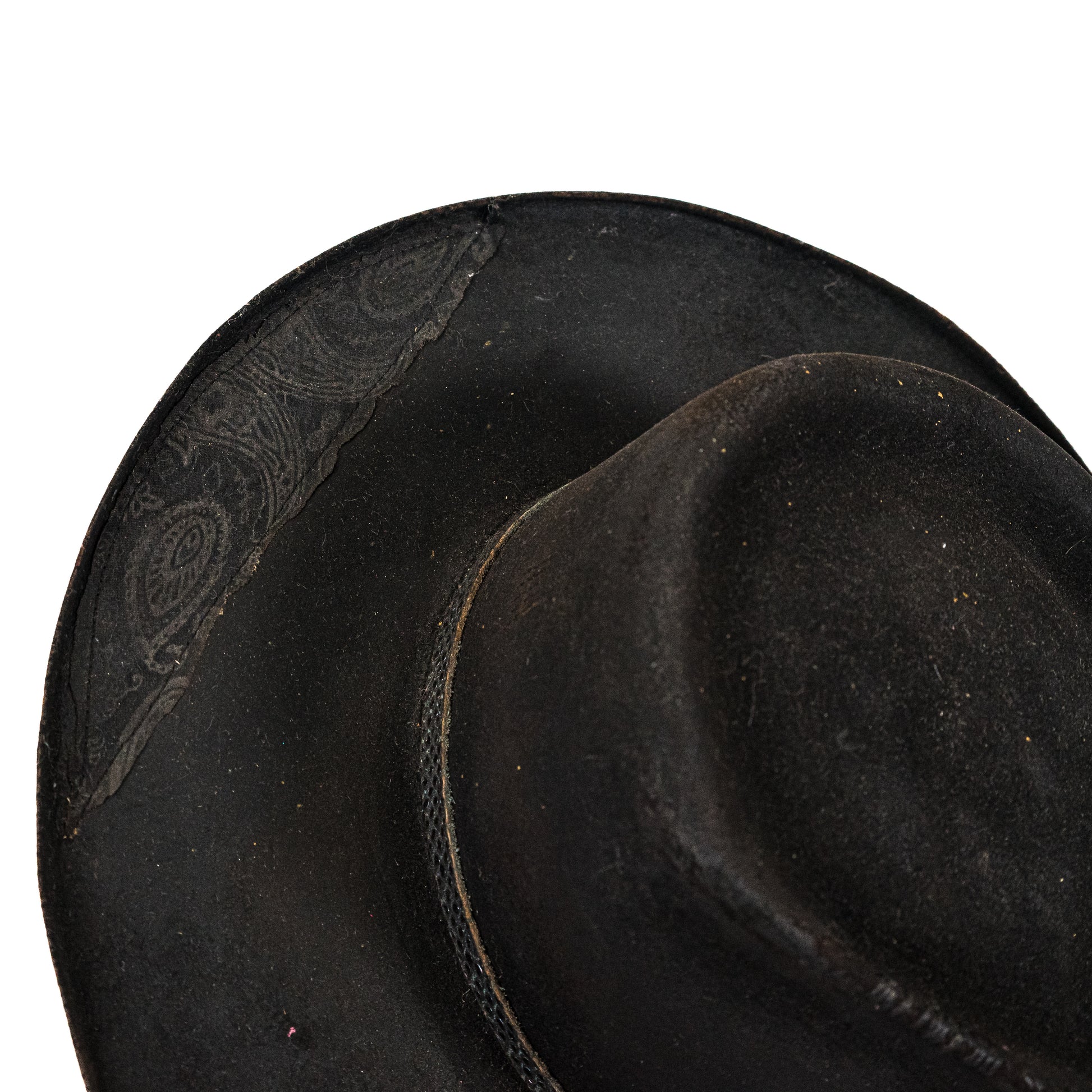 Close-up of heavily distressed black fur felt with burnished brim edges
