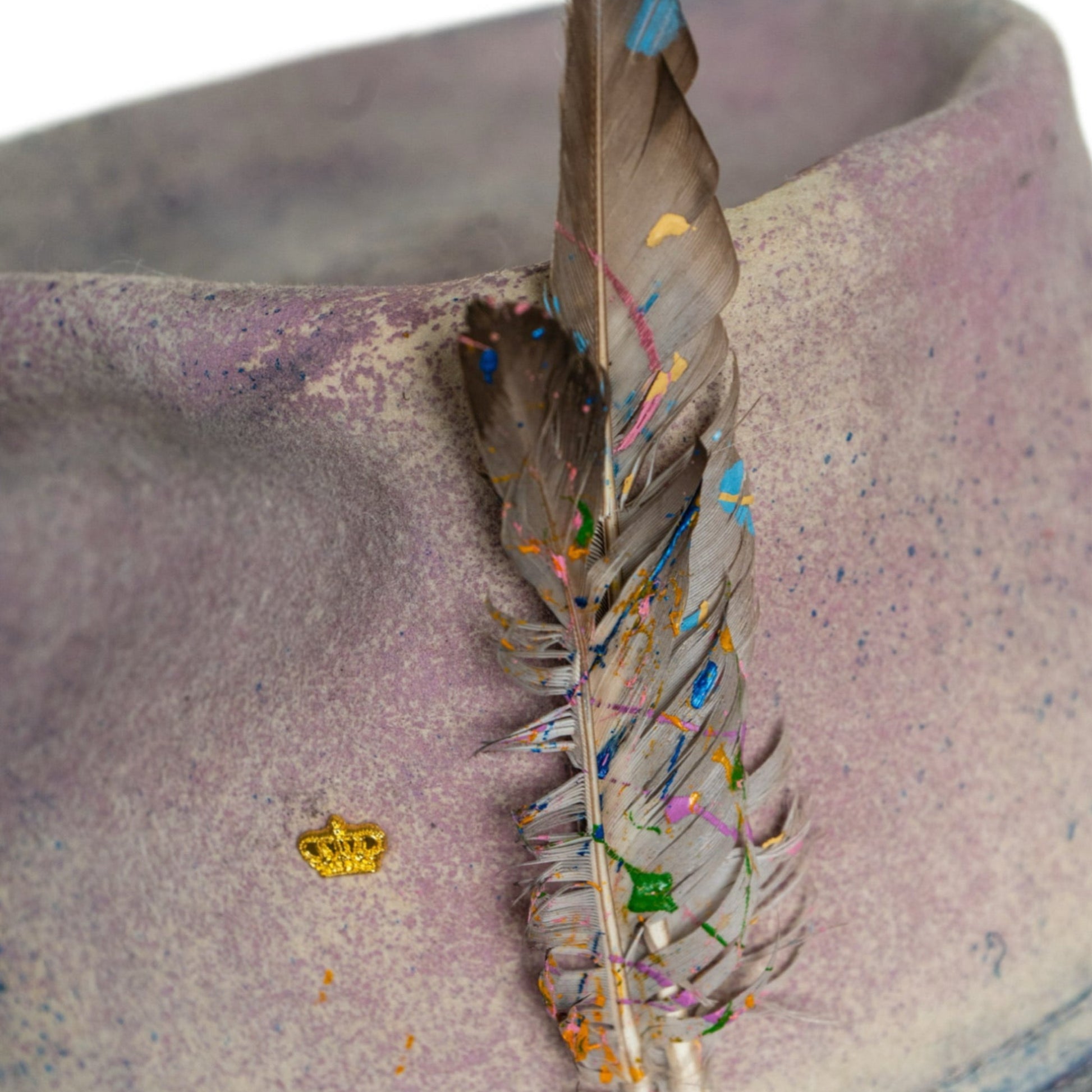 Lumen hand-dyed fur felt hat with paint-splattered feather accents