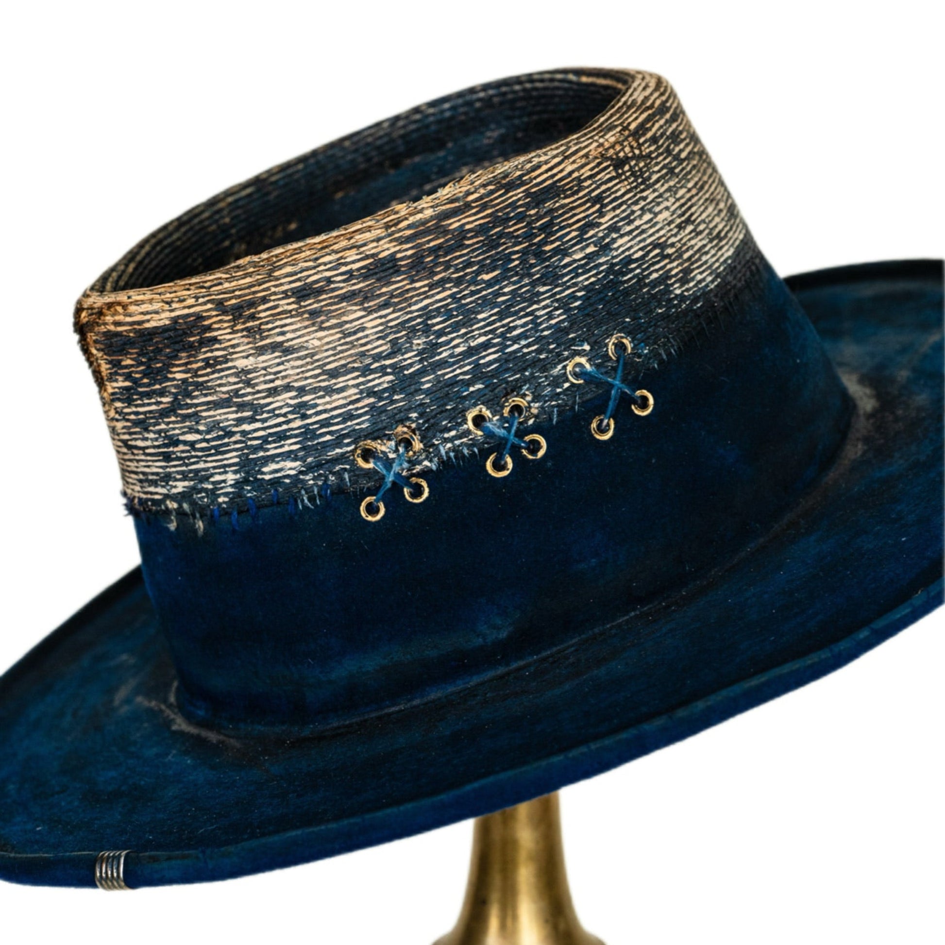 Midnight distressed straw crown with gold metal eyelets and hand stitching
