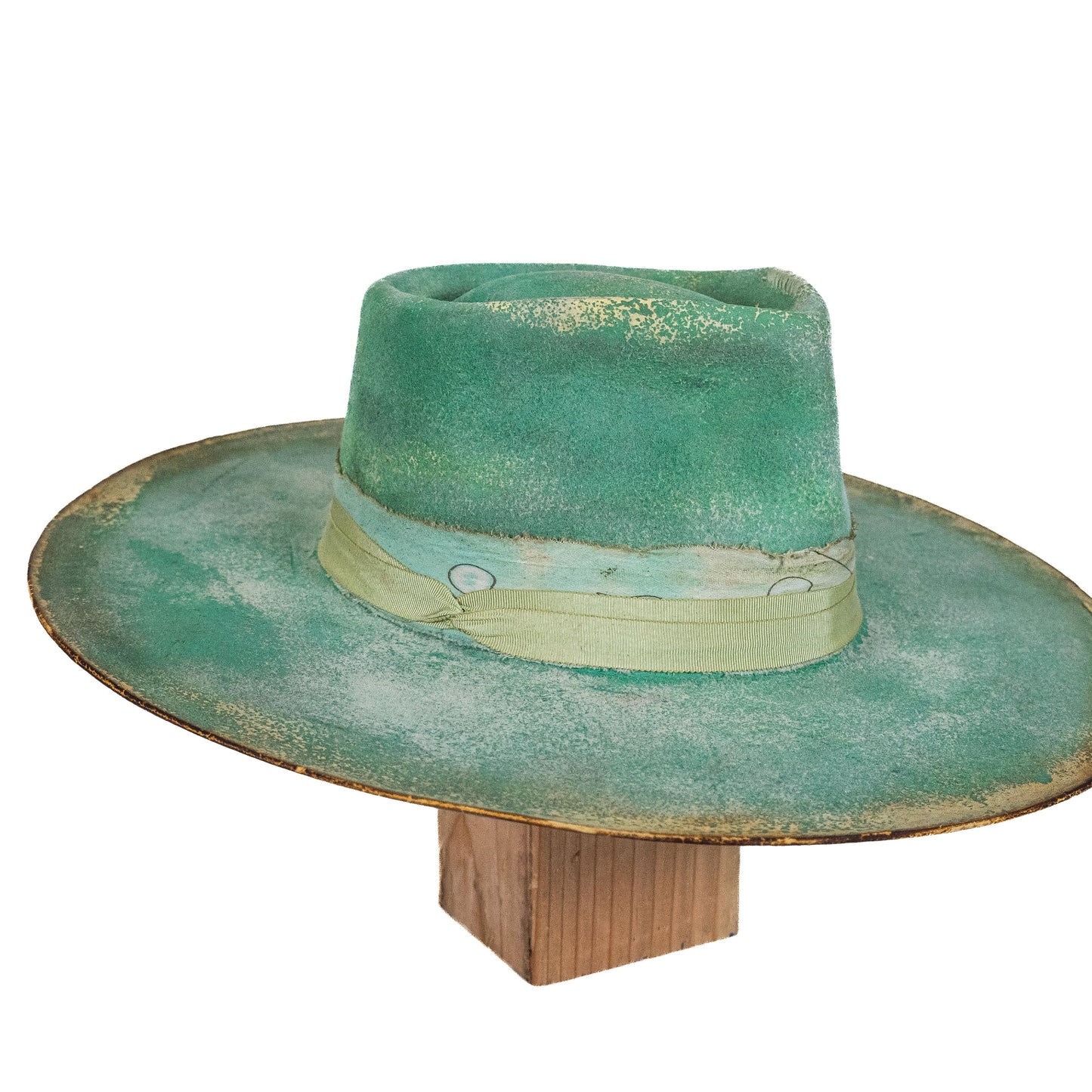 Distressed wide brim fur felt hat showing soft green tonal variation and worn finish

